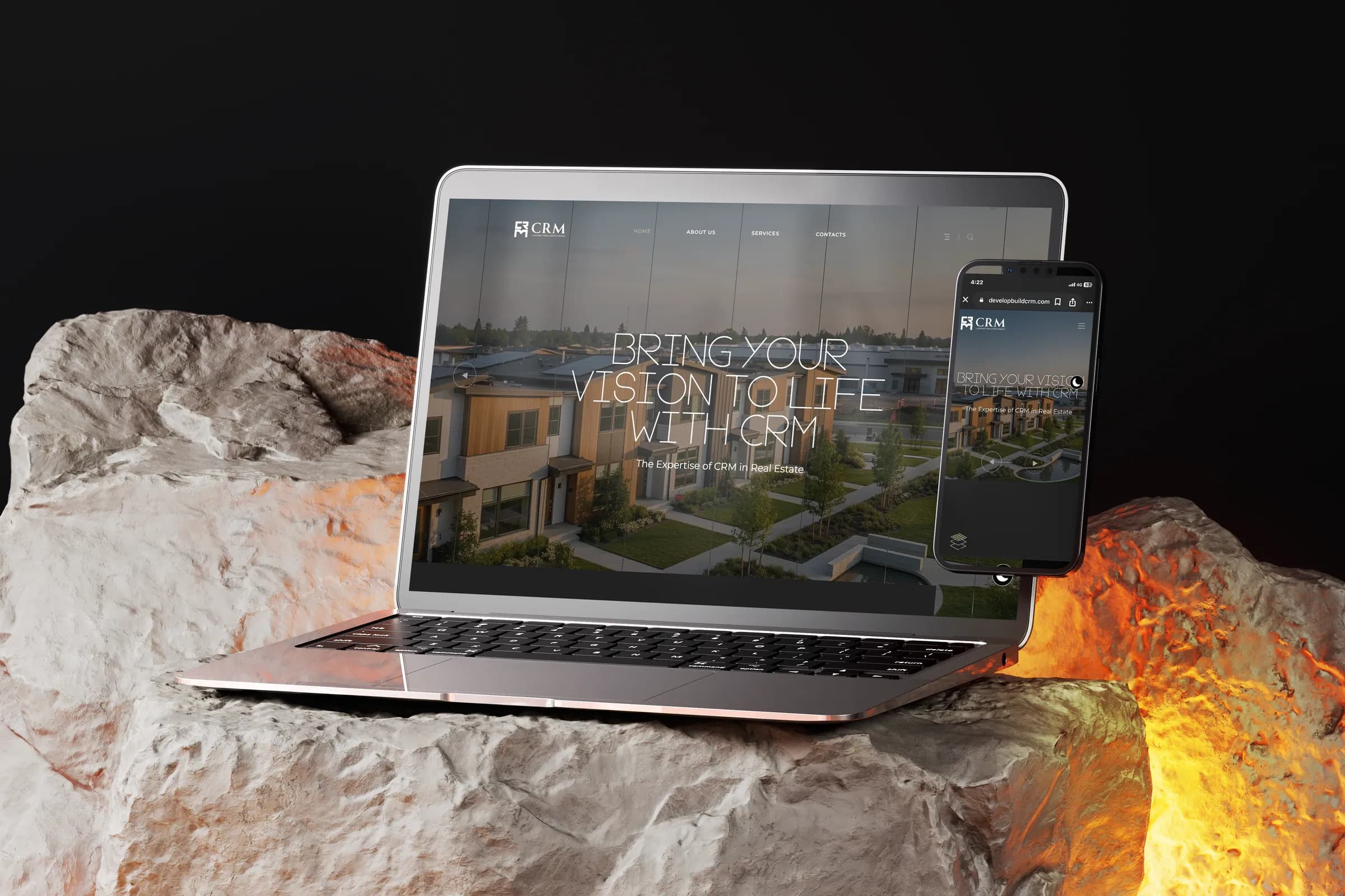 CRM Construction and Development site on a laptop and phone on lit stone